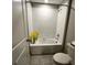 This bathroom features a shower/tub, flowers, and bright white tiles at 12957 Wildflower Meadow Dr, Riverview, FL 33579