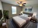 Serene bedroom featuring a gray bed, soft lighting, and contemporary decor, providing a relaxing and stylish retreat at 12957 Wildflower Meadow Dr, Riverview, FL 33579