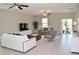 Inviting living room with neutral tones, contemporary furniture, and sliding glass doors offering plenty of natural light at 12957 Wildflower Meadow Dr, Riverview, FL 33579