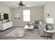 Cozy living room featuring comfortable seating, a ceiling fan, and ample natural light at 12957 Wildflower Meadow Dr, Riverview, FL 33579