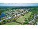 Beautiful aerial view shows a neighborhood with a golf course, ponds, and verdant landscaping, creating a tranquil atmosphere at 13122 Prestwick Dr, Riverview, FL 33579