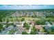 Aerial view of a residential neighborhood with mature trees, golf course, community ponds, and scenic views at 13122 Prestwick Dr, Riverview, FL 33579
