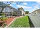 View of the lawn, brick-lined mulch, and privacy fence in backyard at 13122 Prestwick Dr, Riverview, FL 33579