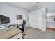 Bedroom setup as an office with a spacious desk, chair, closet and light blue walls at 13122 Prestwick Dr, Riverview, FL 33579