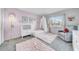 Charming bedroom decorated in pink tones with soft rugs, a white crib, and a comfortable chair at 13122 Prestwick Dr, Riverview, FL 33579