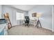 Cozy bedroom featuring a dedicated workspace, complete with a modern desk, chair, and ample natural light at 13122 Prestwick Dr, Riverview, FL 33579