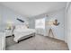 Serene bedroom featuring soft blue walls, plush carpet, a comfortable bed, and decor with a nautical theme at 13122 Prestwick Dr, Riverview, FL 33579