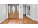 Spacious entryway with a beautiful front door featuring decorative glass, wood flooring, and neutral wall colors at 13122 Prestwick Dr, Riverview, FL 33579