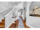 Inviting foyer features wood floors, staircase, decorative niche, and a charming nautical-themed decor at 13122 Prestwick Dr, Riverview, FL 33579