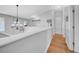Upper hallway boasts hardwood floors, white railing, and a decorative chandelier, creating an inviting atmosphere at 13122 Prestwick Dr, Riverview, FL 33579