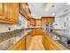 Gourmet kitchen featuring granite countertops, custom wood cabinets, and stainless steel appliances, perfect for culinary enthusiasts at 13122 Prestwick Dr, Riverview, FL 33579