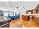 Open-concept living area with hardwood floors, a modern kitchen, large sectional couch, and a home theater setup at 13122 Prestwick Dr, Riverview, FL 33579