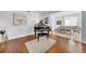 Open living area with baby grand piano and view into dining room at 13122 Prestwick Dr, Riverview, FL 33579