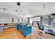 Bright living room with a projector screen, hardwood flooring, modern lighting, and comfortable seating arrangement for entertainment at 13122 Prestwick Dr, Riverview, FL 33579