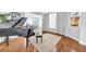 Spacious living room featuring a piano, dining area, and plenty of natural light at 13122 Prestwick Dr, Riverview, FL 33579