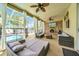 Relaxing covered outdoor patio with plush seating, ceiling fans, and pool views at 13122 Prestwick Dr, Riverview, FL 33579