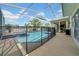 A private pool surrounded by secure fencing with a covered outdoor area at 13122 Prestwick Dr, Riverview, FL 33579