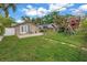 This home features a lush backyard with a playset and quaint landscaping at 138 17Th N Ave, St Petersburg, FL 33704