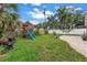 Spacious backyard featuring a playset, landscaped lawn, and a patio area at 138 17Th N Ave, St Petersburg, FL 33704
