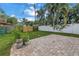 Serene backyard featuring a brick patio, lush lawn, and a privacy fence, creating an inviting outdoor space at 138 17Th N Ave, St Petersburg, FL 33704