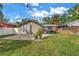 Backyard featuring a brick patio with potted plants, a grill, and a well-maintained lawn at 138 17Th N Ave, St Petersburg, FL 33704