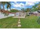 Beautiful backyard with a lush lawn, brick patio, stepping stones and white fence at 138 17Th N Ave, St Petersburg, FL 33704