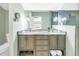 Modern bathroom features double sinks, a large mirror, and a glass shower at 138 17Th N Ave, St Petersburg, FL 33704