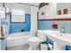 Retro bathroom with blue tiling, a white tub, and vintage fixtures adding a touch of unique character at 138 17Th N Ave, St Petersburg, FL 33704