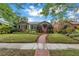 Quaint single-story home featuring a lovely front lawn and inviting brick path at 138 17Th N Ave, St Petersburg, FL 33704