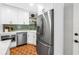 Modern kitchen with stainless steel appliances, white cabinets, and unique tile flooring at 138 17Th N Ave, St Petersburg, FL 33704