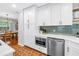 Modern kitchen featuring white cabinets, stainless steel appliances, and eye catching backsplash at 138 17Th N Ave, St Petersburg, FL 33704
