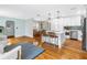 Open-concept kitchen with white cabinetry, stainless steel appliances and hardwood floors at 138 17Th N Ave, St Petersburg, FL 33704