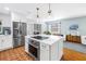 Bright kitchen features a center island, stainless steel appliances, and unique terracotta-colored tile flooring at 138 17Th N Ave, St Petersburg, FL 33704