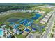 Aerial view showcasing community amenities and surrounding neighborhood, including tennis and bocce ball courts at 14221 Eagle Branch Dr, Nokomis, FL 34275