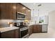 Kitchen featuring stainless steel appliances, granite counters, and dark wood cabinetry at 14221 Eagle Branch Dr, Nokomis, FL 34275