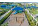 Aerial view of the community playground with swings and slides for children to enjoy at 14221 Eagle Branch Dr, Nokomis, FL 34275