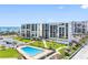 Expansive condo complex with a refreshing outdoor pool, manicured lawns, and scenic waterfront views at 1430 Gulf Blvd # 309, Clearwater Beach, FL 33767