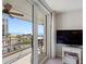 Balcony view shows distant beach, balcony set with table and chairs, visible through glass patio door at 1430 Gulf Blvd # 309, Clearwater Beach, FL 33767