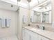 Bright bathroom with a white vanity, granite countertop, and a glass-enclosed shower at 1430 Gulf Blvd # 309, Clearwater Beach, FL 33767