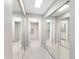 Hallway featuring mirrored closet doors leading to bathroom and additional rooms, enhancing space and light at 1430 Gulf Blvd # 309, Clearwater Beach, FL 33767