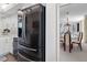 Modern kitchen featuring stainless steel appliances next to living room with table and ocean view at 1430 Gulf Blvd # 309, Clearwater Beach, FL 33767
