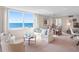 Bright living room boasts a large picture window with stunning ocean views and comfortable seating arrangement at 1430 Gulf Blvd # 309, Clearwater Beach, FL 33767