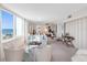 Bright living room boasts a large picture window with stunning ocean views and comfortable seating arrangement at 1430 Gulf Blvd # 309, Clearwater Beach, FL 33767