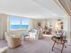 Bright living room boasts a large picture window with stunning ocean views and comfortable seating arrangement at 1430 Gulf Blvd # 309, Clearwater Beach, FL 33767