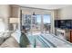 Bright main bedroom featuring a view of the balcony and distant beach, furnished with a queen-sized bed at 1430 Gulf Blvd # 309, Clearwater Beach, FL 33767