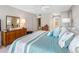 Relaxing bedroom featuring blue-striped bedding and dresser, providing a comfortable retreat at 1430 Gulf Blvd # 309, Clearwater Beach, FL 33767
