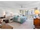Serene main bedroom with balcony access, featuring a queen-sized bed and stylish furnishings at 1430 Gulf Blvd # 309, Clearwater Beach, FL 33767