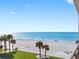Beautiful ocean view from the condo balcony with palm trees and beach access at 1430 Gulf Blvd # 309, Clearwater Beach, FL 33767