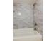 Close up of a shower with updated gray tile surround at 1466 Normandy Park Dr # 4, Clearwater, FL 33756