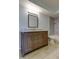 Bathroom featuring a vanity, toilet, and shower with updated gray tile surround at 1466 Normandy Park Dr # 4, Clearwater, FL 33756